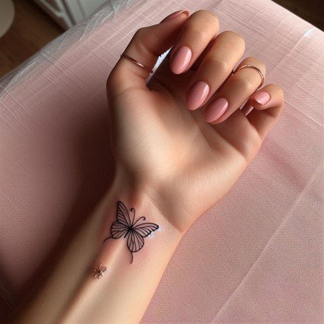 Dainty Butterfly Tattoo on girl's wrist
